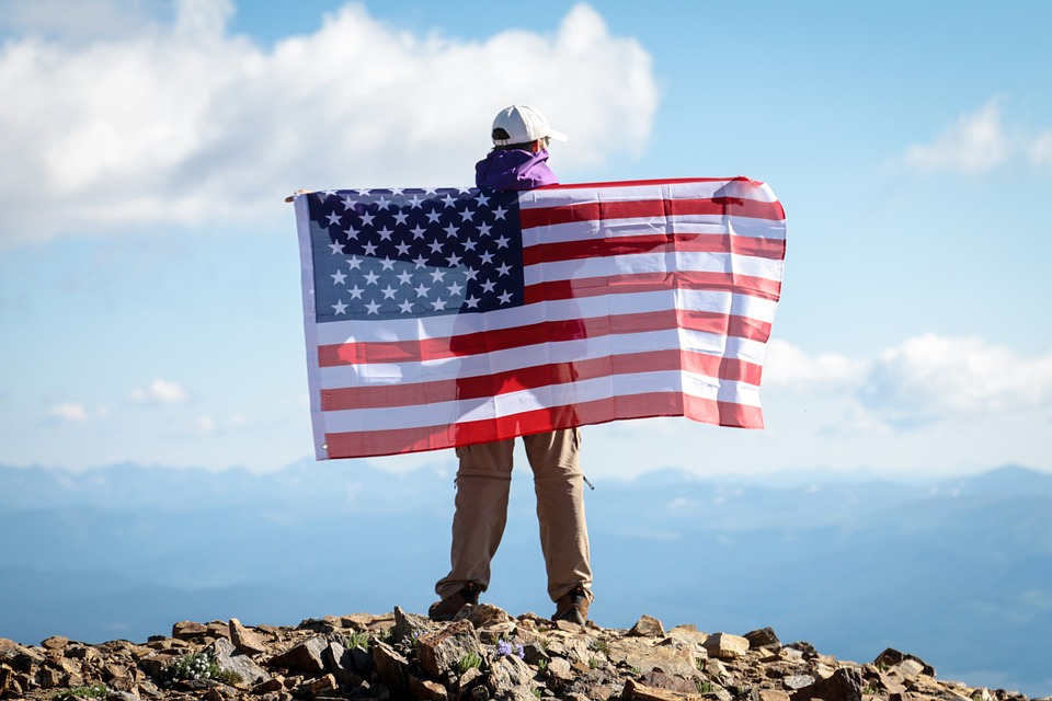 man spreading flag